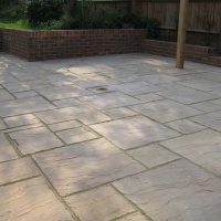 Concrete riven slabs laid to patten and cut to fit
