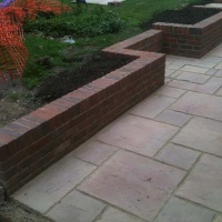 steped garden brick wall and pointed patio